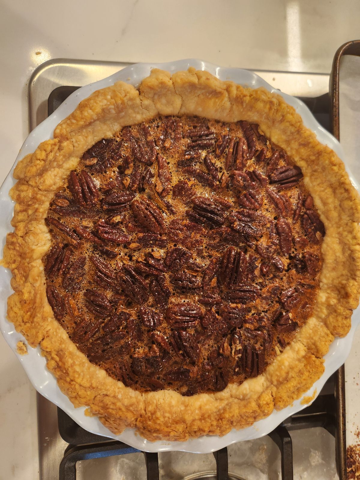 Classic pecan pie in a fluted white dish